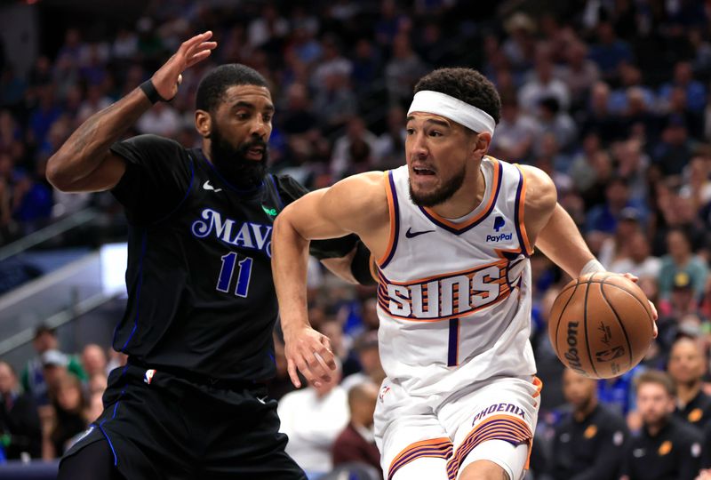 DALLAS, TX - FEBRUARY 22: Devin Booker #1 of the Phoenix Suns drives inside as  Kyrie Irving #11 of the Dallas Mavericks defends in the first half at American Airlines Center on February 22, 2024 in Dallas, Texas. NOTE TO USER: User expressly acknowledges and agrees that, by downloading and or using this photograph, User is consenting to the terms and conditions of the Getty Images License Agreement. (Photo by Ron Jenkins/Getty Images)