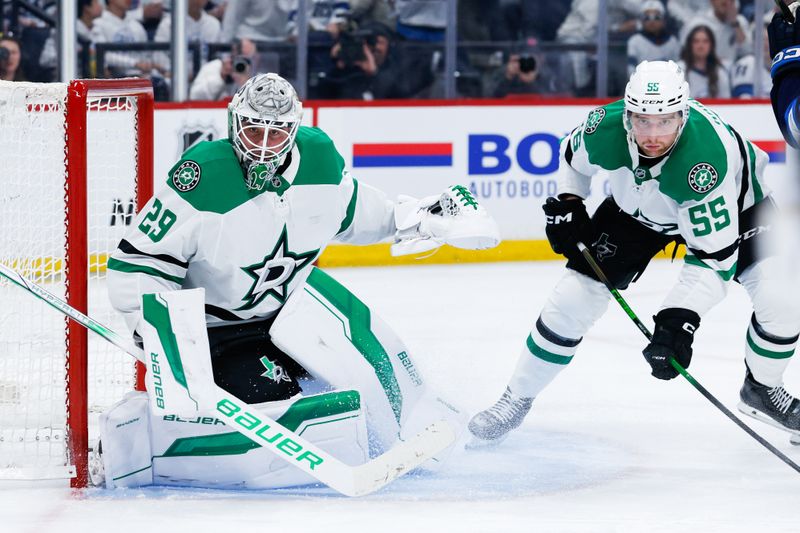 May 7, 2025; Winnipeg, Manitoba, CAN; Dallas Stars goalie Jake Oettinger (29) and Dallas Stars defenseman Thomas Harley (55) defend against the Winnipeg Jets during the second period in game one of the second round of the 2025 Stanley Cup Playoffs at Canada Life Centre. Mandatory Credit: Terrence Lee-Imagn Images