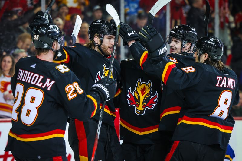 Jan 23, 2024; Calgary, Alberta, CAN; Calgary Flames defenseman Noah Hanifin (55) celebrates his goal with teammates against the St. Louis Blues during the second period at Scotiabank Saddledome. Mandatory Credit: Sergei Belski-USA TODAY Sports