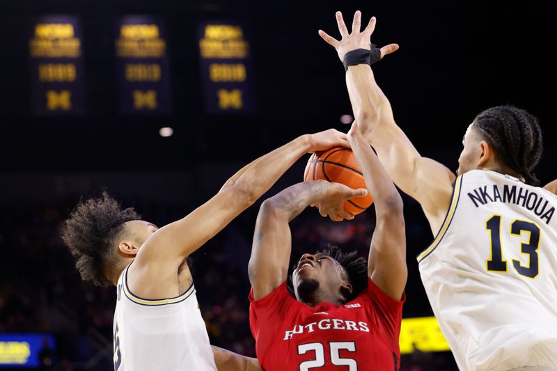 Feb 3, 2024; Ann Arbor, Michigan, USA;  Michigan Wolverines forward Terrance Williams II (5) blocks a shot by Rutgers Scarlet Knights guard Jeremiah Williams (25) in the second half at Crisler Center. Mandatory Credit: Rick Osentoski-USA TODAY Sports