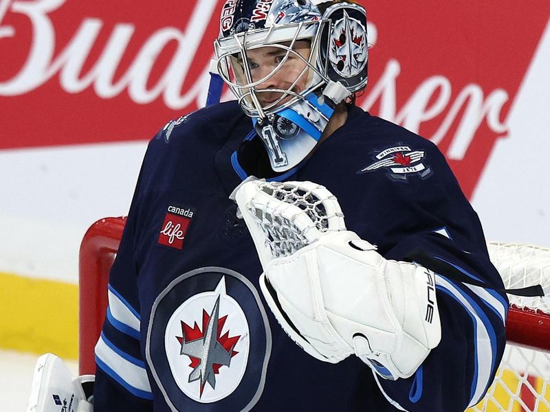 Nov 1, 2025; Winnipeg, Manitoba, CAN; Winnipeg Jets goaltender Eric Comrie (1) celebrates their victory against the Pittsburgh Penguins at Canada Life Centre. Mandatory Credit: James Carey Lauder-Imagn Images