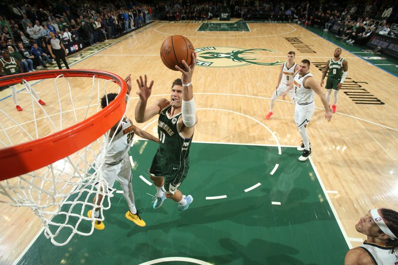 MILWAUKEE, WI - FEBRUARY 27: Brook Lopez #11 of the Milwaukee Bucks drives to the basket during the game against the Denver Nuggets on February 27, 2025 at Fiserv Forum Center in Milwaukee, Wisconsin. NOTE TO USER: User expressly acknowledges and agrees that, by downloading and or using this Photograph, user is consenting to the terms and conditions of the Getty Images License Agreement. Mandatory Copyright Notice: Copyright 2025 NBAE (Photo by Gary Dineen/NBAE via Getty Images).