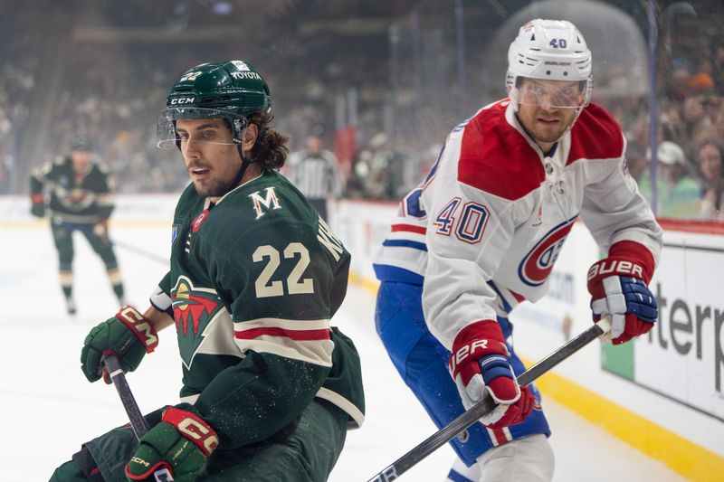 Nov 14, 2024; Saint Paul, Minnesota, USA; Minnesota Wild center Marat Khusnutdinov (22) escapes from a check from Montreal Canadiens right wing Joel Armia (40) in the first period at Xcel Energy Center. Mandatory Credit: Matt Blewett-Imagn Images