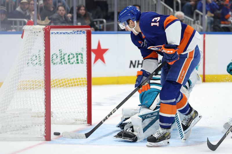 Jan 18, 2025; Elmont, New York, USA;  New York Islanders center Mathew Barzal (13) scores a goal against the San Jose Sharks during the second period at UBS Arena. Mandatory Credit: Thomas Salus-Imagn Images