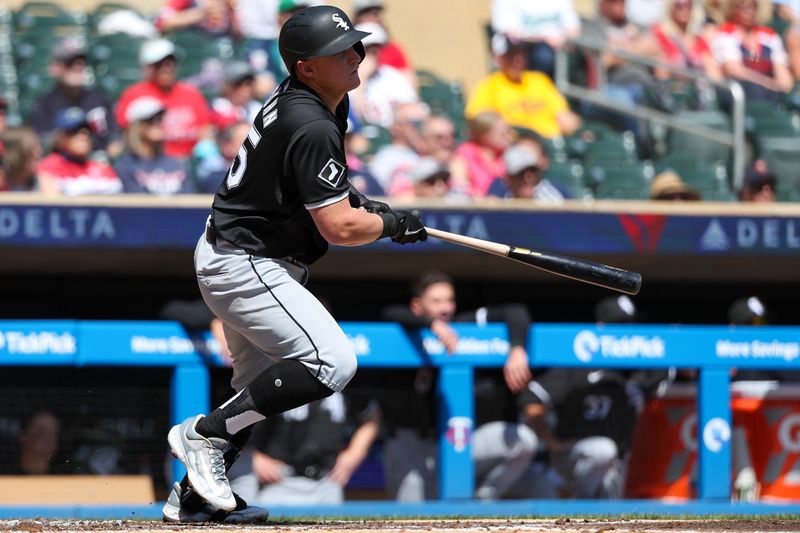 Apr 25, 2024; Minneapolis, Minnesota, USA; Chicago White Sox first base Andrew Vaughn (25) hits a single against the Minnesota Twins during the second inning at Target Field. Mandatory Credit: Matt Krohn-USA TODAY Sports