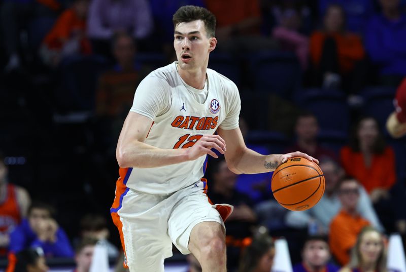 Jan 25, 2023; Gainesville, Florida, USA; Florida Gators forward Colin Castleton (12) dribbles against the South Carolina Gamecocks during the second half at Exactech Arena at the Stephen C. O'Connell Center. Mandatory Credit: Kim Klement-USA TODAY Sports