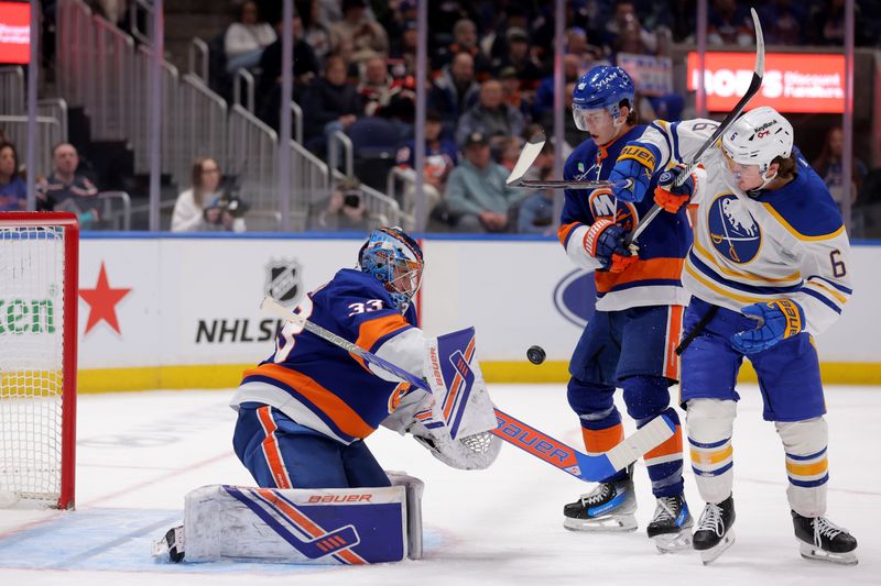 Jan 24, 2026; Elmont, New York, USA; New York Islanders goaltender David Rittich (33) plays the puck in front of Islanders defenseman Matthew Schaefer (48) and Buffalo Sabres left wing Zach Benson (6) during the first period at UBS Arena. Mandatory Credit: Brad Penner-Imagn Images