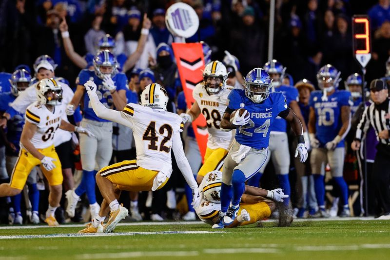 Oct 14, 2023; Colorado Springs, Colorado, USA; Air Force Falcons running back John Lee Eldridge III (24) runs the ball for a touchdown as Wyoming Cowboys safety Isaac White (42) defends in the fourth quarter at Falcon Stadium. Mandatory Credit: Isaiah J. Downing-USA TODAY Sports