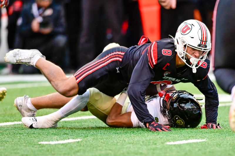 Nov 25, 2023; Salt Lake City, Utah, USA; Colorado Buffaloes running back Dylan Edwards (3) gets tackled by Utah Utes safety Cole Bishop (8) at Rice-Eccles Stadium. Mandatory Credit: Christopher Creveling-USA TODAY Sports