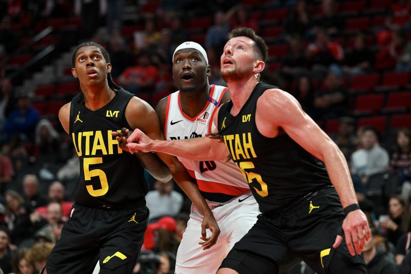 PORTLAND, OREGON - OCTOBER 18: Duop Reath #26 of the Portland Trail Blazers battles wtih Cody Williams #5 and Drew Eubanks #15 of the Utah Jazz during the third quarter of the preseason game at Moda Center on October 18, 2024 in Portland, Oregon. NOTE TO USER: User expressly acknowledges and agrees that, by downloading and or using this photograph, User is consenting to the terms and conditions of the Getty Images License Agreement. (Photo by Alika Jenner/Getty Images)