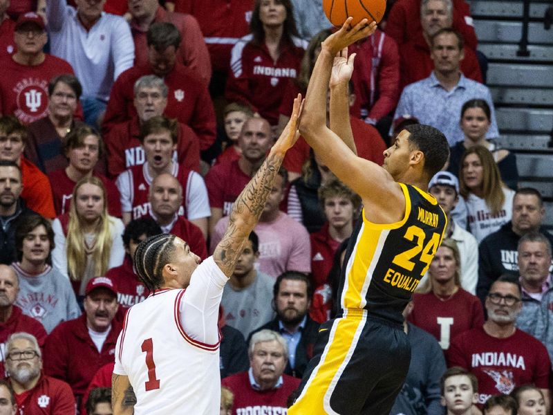 Feb 28, 2023; Bloomington, Indiana, USA; Iowa Hawkeyes forward Kris Murray (24) shoots the ball while Indiana Hoosiers guard Jalen Hood-Schifino (1) defends in the first half at Simon Skjodt Assembly Hall. Mandatory Credit: Trevor Ruszkowski-USA TODAY Sports