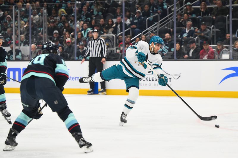 Nov 30, 2024; Seattle, Washington, USA; San Jose Sharks center Alexander Wennberg (21) shoots the puck against the Seattle Kraken during the first period at Climate Pledge Arena. Mandatory Credit: Steven Bisig-Imagn Images