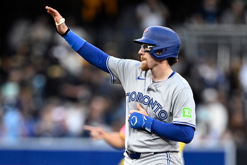Apr 19, 2024; San Diego, California, USA; Toronto Blue Jays catcher Danny Jansen (9) celebrates after hitting a double against the San Diego Padres during the second inning at Petco Park. Mandatory Credit: Orlando Ramirez-USA TODAY Sports 