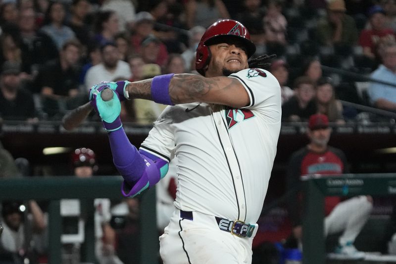 May 6, 2025; Phoenix, Arizona, USA; Arizona Diamondbacks second base Ketel Marte (4) reacts after missing the pitch against the New York Mets in the eighth inning at Chase Field. Mandatory Credit: Rick Scuteri-Imagn Images