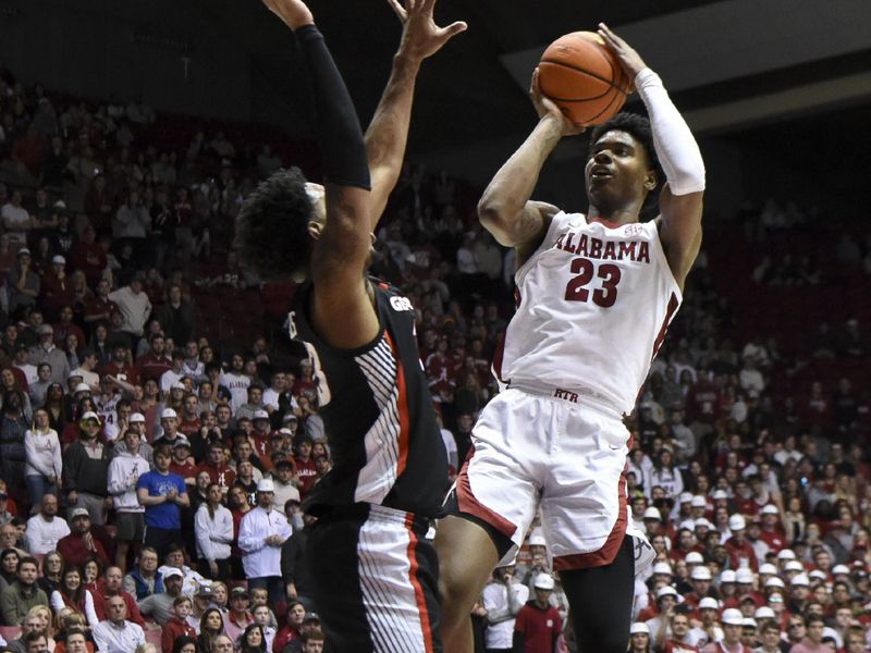 Feb 18, 2023; Tuscaloosa, Alabama, USA; Alabama Crimson Tide forward Nick Pringle (23) scores in the lane over Georgia Bulldogs guard Mardrez McBride (13) at Coleman Coliseum. Alabama won 108-59. Mandatory Credit: Gary Cosby Jr.-USA TODAY Sports