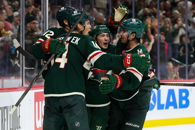 Oct 10, 2024; Saint Paul, Minnesota, USA; Minnesota Wild center Joel Eriksson Ek (14) celebrates his goal with teammates against the Columbus Blue Jackets during the second period at Xcel Energy Center. Mandatory Credit: Matt Krohn-Imagn Images