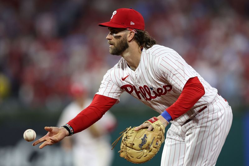 Oct 3, 2023; Philadelphia, Pennsylvania, USA; Philadelphia Phillies designated hitter Bryce Harper (3) throws the ball to first base for the out against the Miami Marlins in the sixth inning for game one of the Wildcard series for the 2023 MLB playoffs at Citizens Bank Park. Mandatory Credit: Bill Streicher-USA TODAY Sports