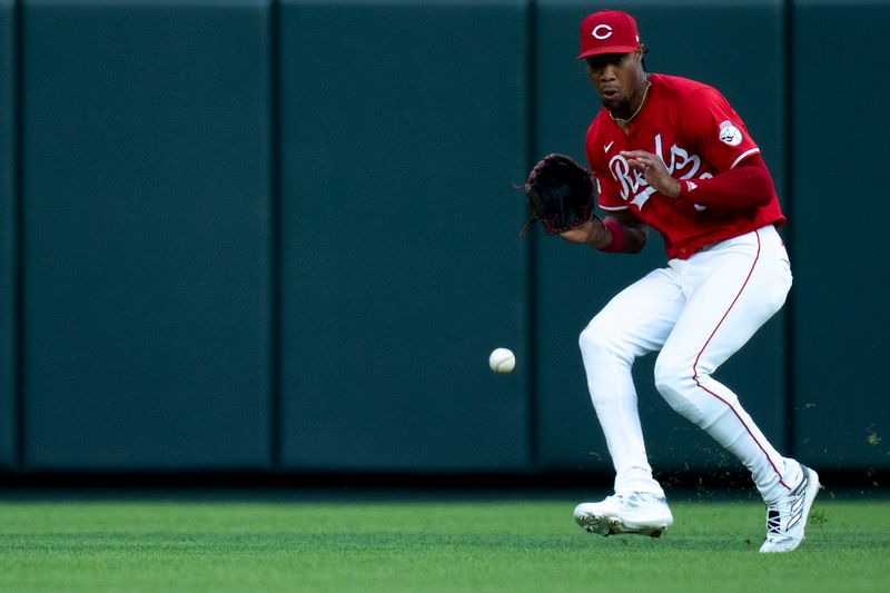 May 28, 2024; Cincinnati, Ohio, USA; Cincinnati Reds outfielder Will Benson (30) fields a ground ball in the sixth inning at Great American Ball Park. Mandatory Credit: Albert Cesare-USA TODAY Sports