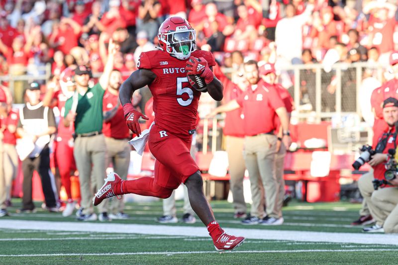 Sep 16, 2023; Piscataway, New Jersey, USA; Rutgers Scarlet Knights running back Kyle Monangai (5) scores his third rushing touchdown of the game during the fourth quarter against the Virginia Tech Hokies at SHI Stadium. Mandatory Credit: Vincent Carchietta-USA TODAY Sports