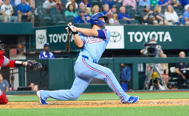 May 19, 2024; Arlington, Texas, USA; Texas Rangers shortstop Corey Seager (5) hits a home run during the fourth inning against the Los Angeles Angels at Globe Life Field. Mandatory Credit: Kevin Jairaj-USA TODAY Sports