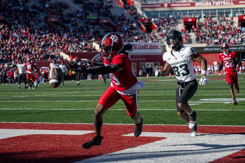 Nov 18, 2023; Bloomington, Indiana, USA; Indiana Hoosiers defensive back Josh Sanguinetti (19) misses an opportunity to intercept a ball meant for Michigan State Spartans wide receiver Montorie Foster Jr. (83) during the second half at Memorial Stadium. Mandatory Credit: Marc Lebryk-USA TODAY Sports