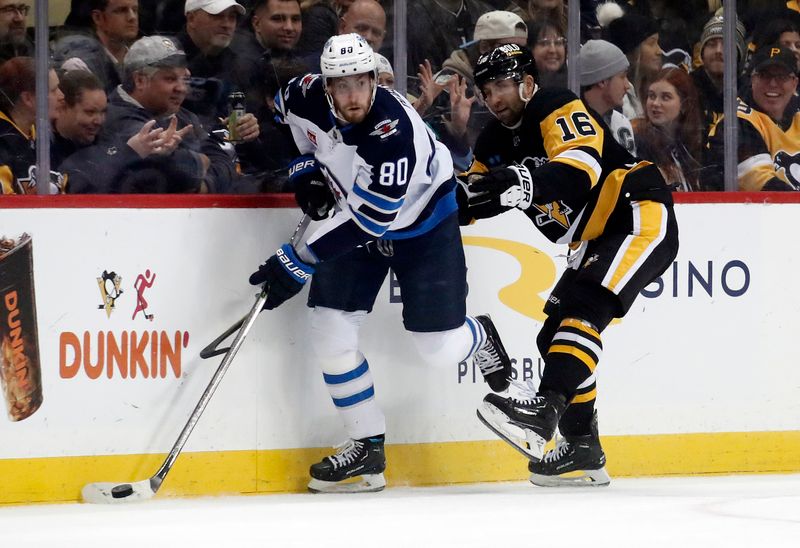 Jan 13, 2023; Pittsburgh, Pennsylvania, USA;  Winnipeg Jets left wing Pierre-Luc Dubois (80) moves the puck against Pittsburgh Penguins left wing Jason Zucker (16) during the first period at PPG Paints Arena. Mandatory Credit: Charles LeClaire-USA TODAY Sports