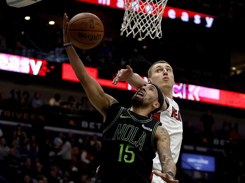 NEW ORLEANS, LOUISIANA - FEBRUARY 23: Nikola Jovic #5 of the Miami Heat blocks the shot of Jose Alvarado #15 of the New Orleans Pelicans during the second quarter of an NBA game at Smoothie King Center on February 23, 2024 in New Orleans, Louisiana. NOTE TO USER: User expressly acknowledges and agrees that, by downloading and or using this photograph, User is consenting to the terms and conditions of the Getty Images License Agreement. (Photo by Sean Gardner/Getty Images)