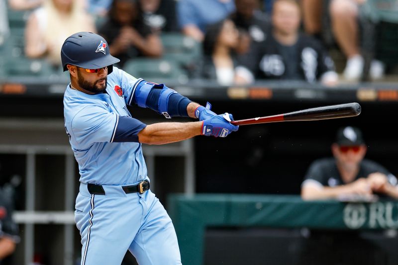 May 27, 2024; Chicago, Illinois, USA; Toronto Blue Jays third baseman Isiah Kiner-Falefa (7) doubles against the Chicago White Sox during the fourth inning at Guaranteed Rate Field. Mandatory Credit: Kamil Krzaczynski-USA TODAY Sports