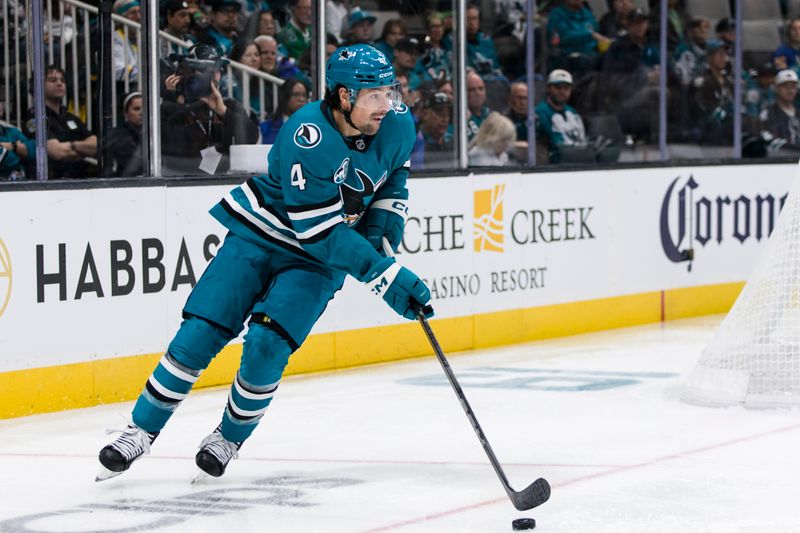 Nov 23, 2024; San Jose, California, USA; San Jose Sharks defenseman Cody Ceci (4) clears the puck against the Buffalo Sabres during the first period at SAP Center in San Jose. Mandatory Credit: John Hefti-Imagn Images