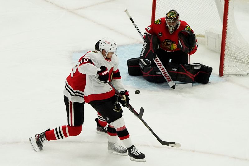 Feb 17, 2024; Chicago, Illinois, USA; Ottawa Senators center Tim Stutzle (18) shoots the puck on Chicago Blackhawks goalie Petr Mrazek (34) during the first period at United Center. Mandatory Credit: David Banks-USA TODAY Sports