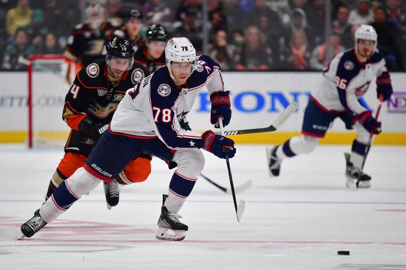 Feb 21, 2024; Anaheim, California, USA; Columbus Blue Jackets defenseman Damon Severson (78) moves in for the puck ahead of Anaheim Ducks center Adam Henrique (14) during the third period at Honda Center. Mandatory Credit: Gary A. Vasquez-USA TODAY Sports