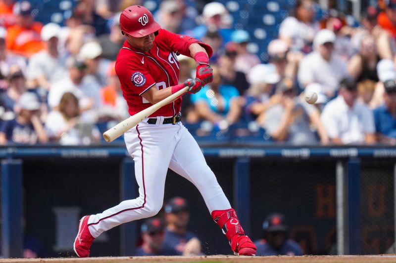 Mar 13, 2023; West Palm Beach, Florida, USA; Washington Nationals left fielder Lane Thomas (28) hits a home run against the Houston Astros during the second inning at The Ballpark of the Palm Beaches. Mandatory Credit: Rich Storry-USA TODAY Sports