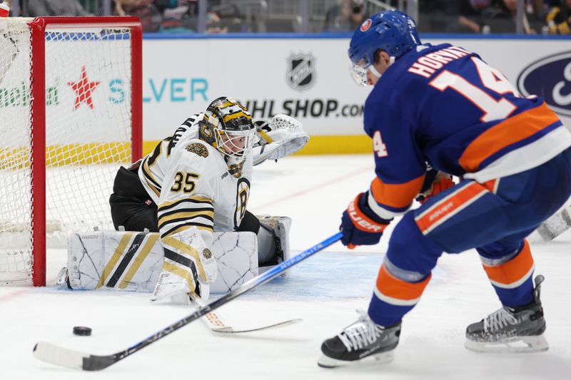 Mar 2, 2024; Elmont, New York, USA; Boston Bruins goaltender Linus Ullmark (35) makes a save against New York Islanders center Bo Horvat (14) during the second period at UBS Arena. Mandatory Credit: Brad Penner-USA TODAY Sports