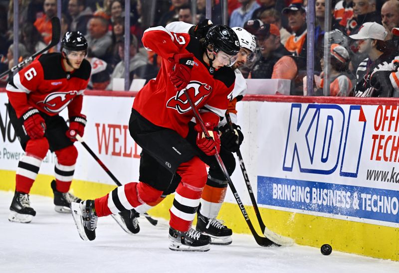 Apr 13, 2024; Philadelphia, Pennsylvania, USA; New Jersey Devils defenseman Luke Hughes (43) battles for the puck against Philadelphia Flyers left wing Noah Cates (27) in the first period at Wells Fargo Center. Mandatory Credit: Kyle Ross-USA TODAY Sports