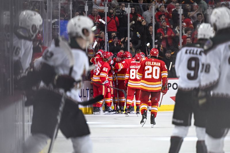 Jan 16, 2024; Calgary, Alberta, CAN; Calgary Flames center Yegor Sharangovich (17) and teammates celebrate after beating the Arizona Coyotes 3-2 in overtime at Scotiabank Saddledome. Mandatory Credit: Brett Holmes-USA TODAY Sports