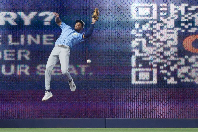 May 17, 2025; Miami, Florida, USA;  Tampa Bay Rays center fielder Chandler Simpson (14) misses a fly ball against the Miami Marlins during the fourth inning at loanDepot Park. Mandatory Credit: Rhona Wise-Imagn Images