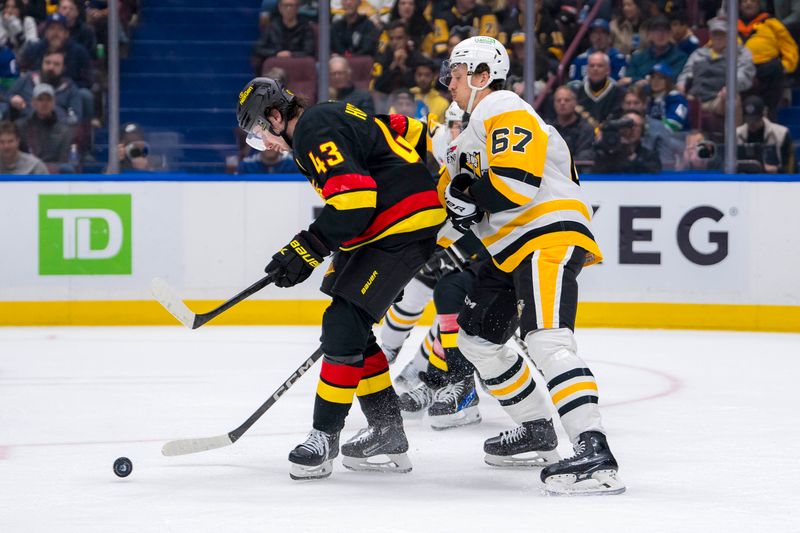 Oct 26, 2024; Vancouver, British Columbia, CAN; Pittsburgh Penguins forward Rickard Rakell (67) battles with Vancouver Canucks defenseman Quinn Hughes (43) during the second period at Rogers Arena. Mandatory Credit: Bob Frid-Imagn Images