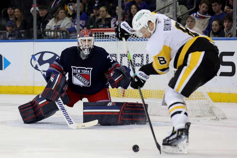 Dec 6, 2024; New York, New York, USA; Pittsburgh Penguins left wing Michael Bunting (8) plays the puck against New York Rangers goaltender Igor Shesterkin (31) during the second period at Madison Square Garden. Mandatory Credit: Brad Penner-Imagn Images