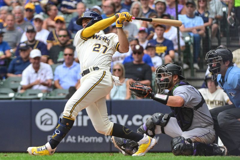 Aug 9, 2023; Milwaukee, Wisconsin, USA;  Milwaukee Brewers shortstop Willy Adames (27) hits a solo home run as Colorado Rockies catcher Austin Wynns (16) looks on during the fifth inning at American Family Field. Mandatory Credit: Benny Sieu-USA TODAY Sports
