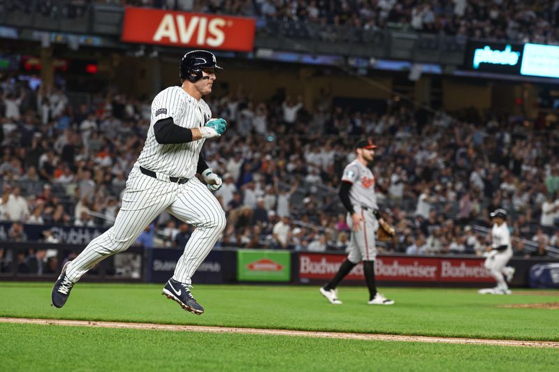 Sep 26, 2024; Bronx, New York, USA; New York Yankees first baseman Anthony Rizzo (48) hits a two RBI single during the sixth inning against the Baltimore Orioles at Yankee Stadium. Mandatory Credit: Vincent Carchietta-Imagn Images