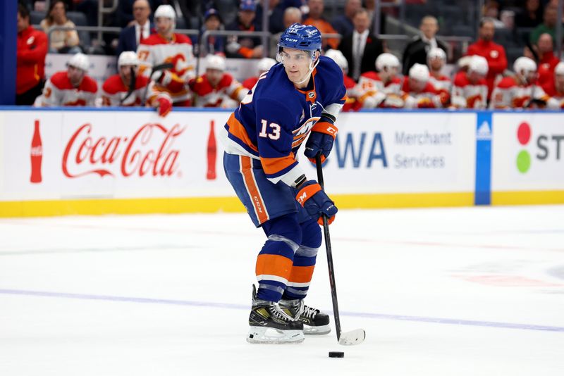 Nov 7, 2022; Elmont, New York, USA; New York Islanders center Mathew Barzal (13) controls the puck against the Calgary Flames during overtime at UBS Arena. Mandatory Credit: Brad Penner-USA TODAY Sports