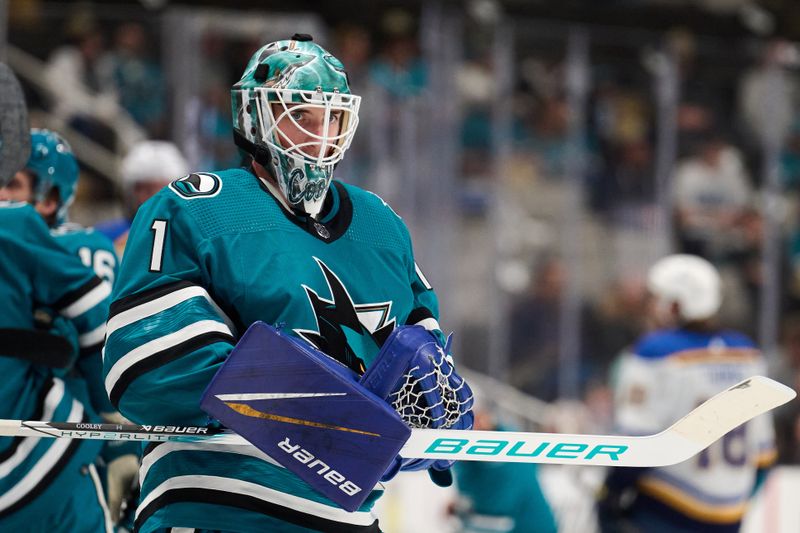 Apr 6, 2024; San Jose, California, USA; San Jose Sharks goaltender Devin Cooley (1) waits for play to resume against the St. Louis Blues during the first period at SAP Center at San Jose. Mandatory Credit: Robert Edwards-USA TODAY Sports
