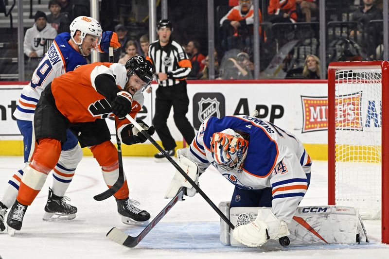 Nov 12, 2025; Philadelphia, Pennsylvania, USA; Edmonton Oilers goaltender Stuart Skinner (74) makes a save against Philadelphia Flyers center Sean Couturier (14) during the first period at Xfinity Mobile Arena. Mandatory Credit: Eric Hartline-Imagn Images