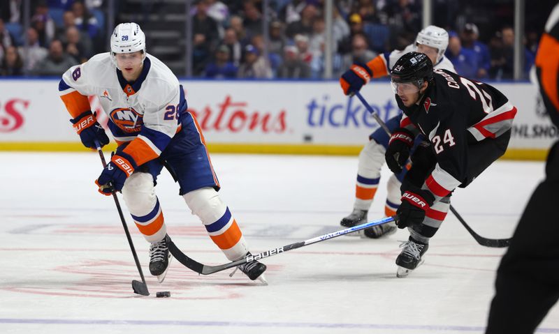 Nov 1, 2024; Buffalo, New York, USA;  New York Islanders defenseman Alexander Romanov (28) skates with the puck as Buffalo Sabres center Dylan Cozens (24) defends during the third period at KeyBank Center. Mandatory Credit: Timothy T. Ludwig-Imagn Images