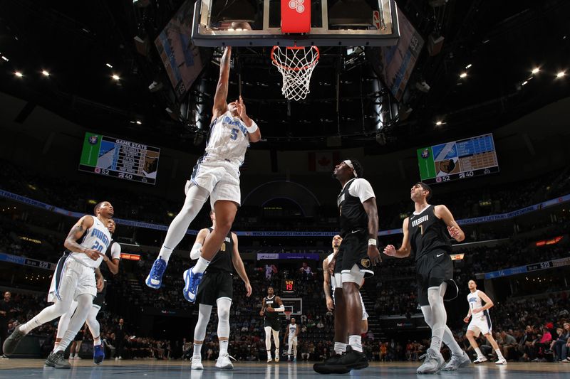 MEMPHIS, TN - JANUARY 26:  Paolo Banchero #5 of the Orlando Magic drives to the basket during the game against the Memphis Grizzlies on January 26, 2024 at FedExForum in Memphis, Tennessee. NOTE TO USER: User expressly acknowledges and agrees that, by downloading and or using this photograph, User is consenting to the terms and conditions of the Getty Images License Agreement. Mandatory Copyright Notice: Copyright 2024 NBAE (Photo by Joe Murphy/NBAE via Getty Images)