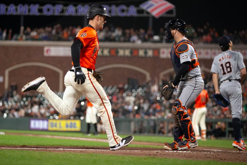 Aug 9, 2024; San Francisco, California, USA; San Francisco Giants designated hitter Mark Canha (16) scores the tying run on a sacrifice fly as Detroit Tigers catcher Jake Rogers (34) waits on the late throw during the eighth inning at Oracle Park. Mandatory Credit: D. Ross Cameron-USA TODAY Sports