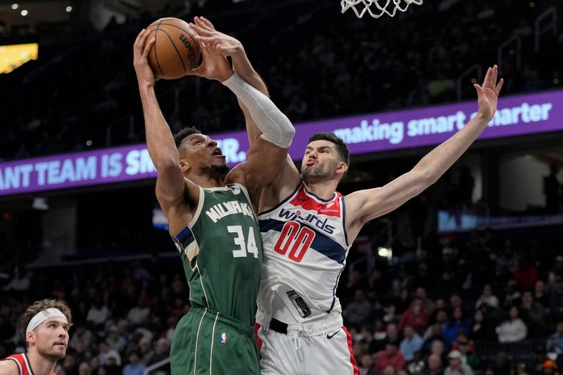 WASHINGTON, DC - APRIL 02: Giannis Antetokounmpo #34 of the Milwaukee Bucks goes up against Tristan Vukcevic #00 of the Washington Wizards during the first half at Capital One Arena on April 02, 2024 in Washington, DC. NOTE TO USER: User expressly acknowledges and agrees that, by downloading and or using this photograph, User is consenting to the terms and conditions of the Getty Images License Agreement. (Photo by Jess Rapfogel/Getty Images)