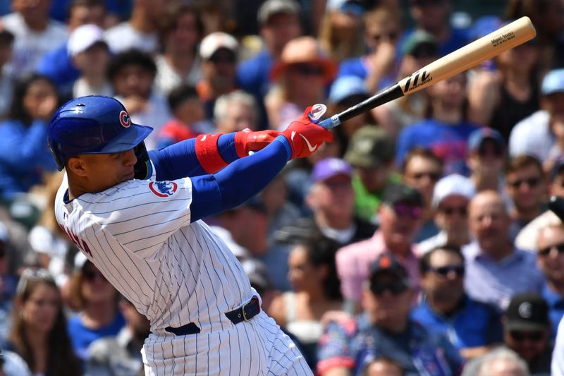 Aug 22, 2024; Chicago, Illinois, USA; Chicago Cubs catcher Miguel Amaya (9) hits a grand slam during the second inning against the Detroit Tigers at Wrigley Field. Mandatory Credit: Patrick Gorski-USA TODAY Sports
