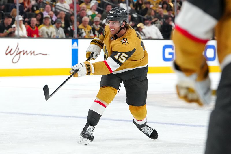 Apr 12, 2024; Las Vegas, Nevada, USA; Vegas Golden Knights defenseman Noah Hanifin (15) shoots against the Minnesota Wild during the second period at T-Mobile Arena. Mandatory Credit: Stephen R. Sylvanie-USA TODAY Sports