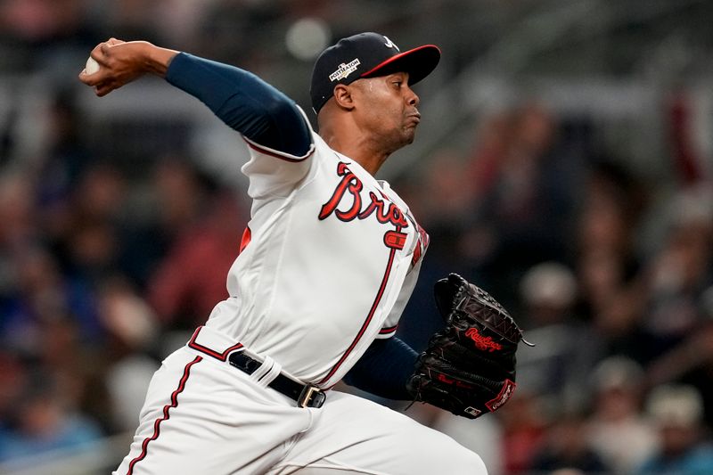 Oct 12, 2022; Atlanta, Georgia, USA; Atlanta Braves relief pitcher Raisel Iglesias (26) throws against the Philadelphia Phillies in the eighth inning during game two of the NLDS for the 2022 MLB Playoffs at Truist Park. Mandatory Credit: Dale Zanine-USA TODAY Sports